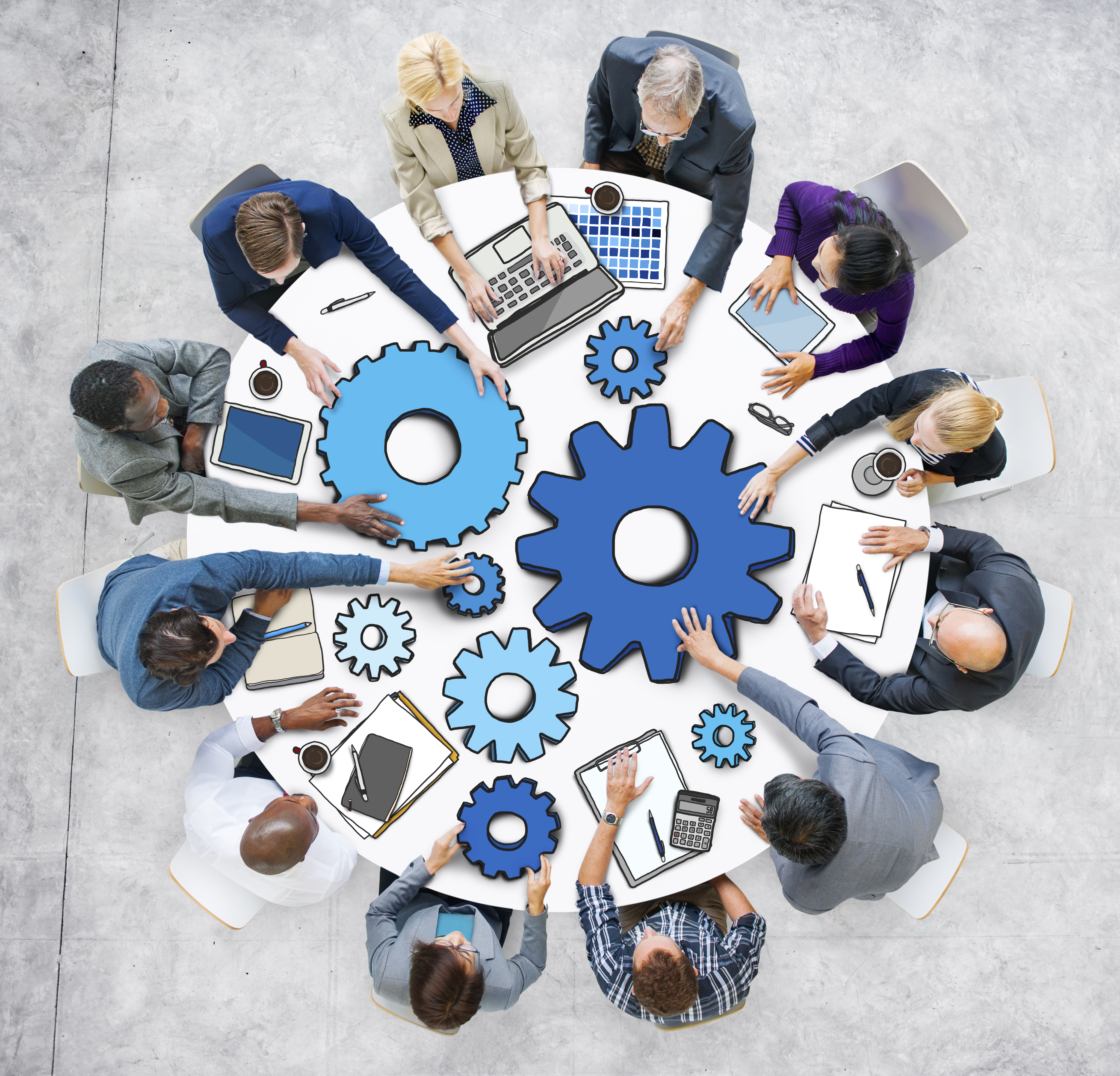 Group seated at a table with graphics of cog wheels